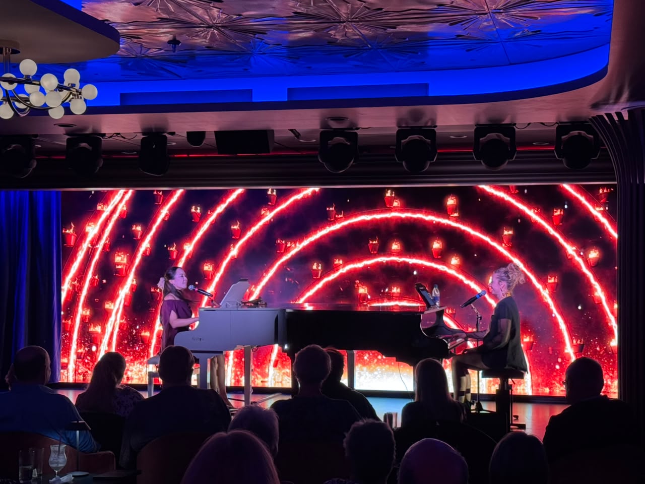 Tammy Ying and Melissa Tormene performing together at facing grand pianos on stage